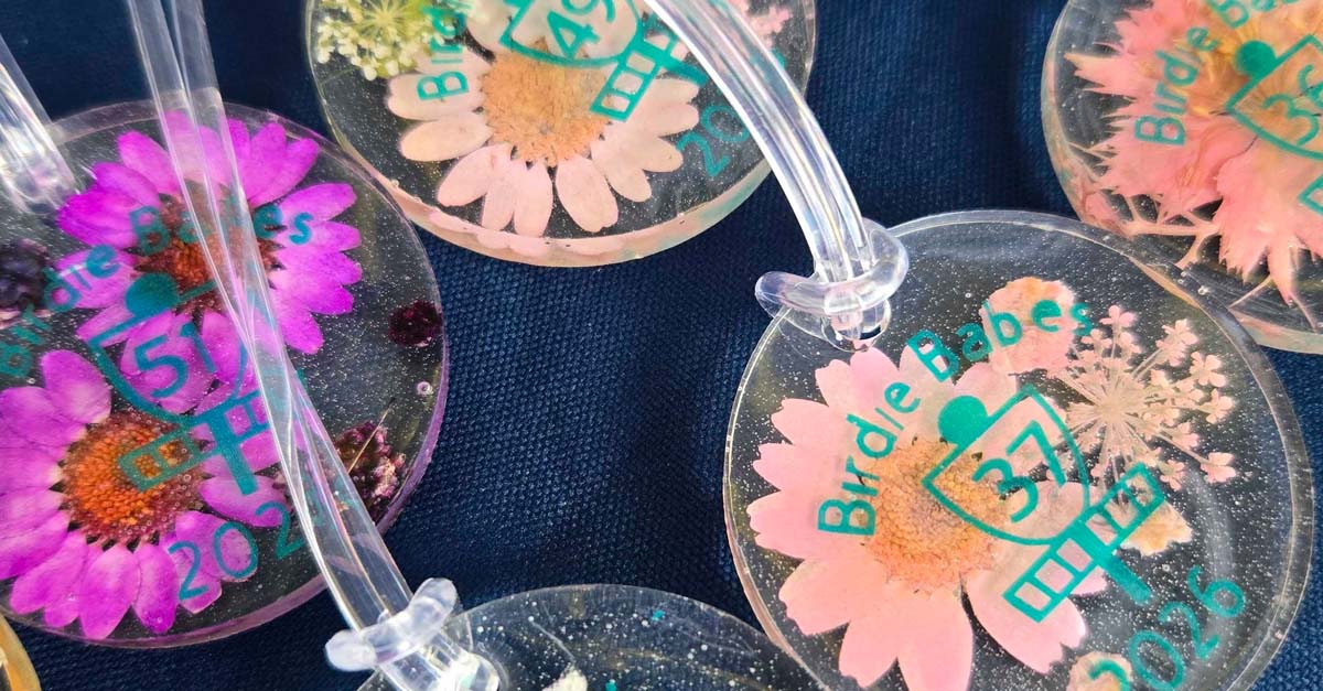 Disc golf bag tags that are see-through and have pressed wildflowers in them
