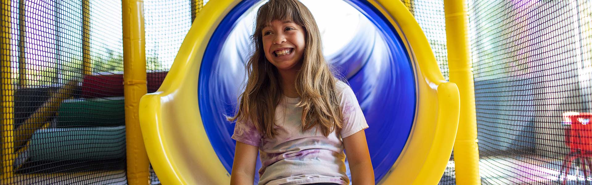 Young girl playing on indoor slide