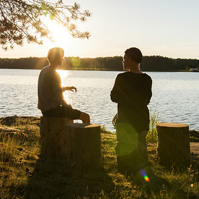 A couple talking at sunset.