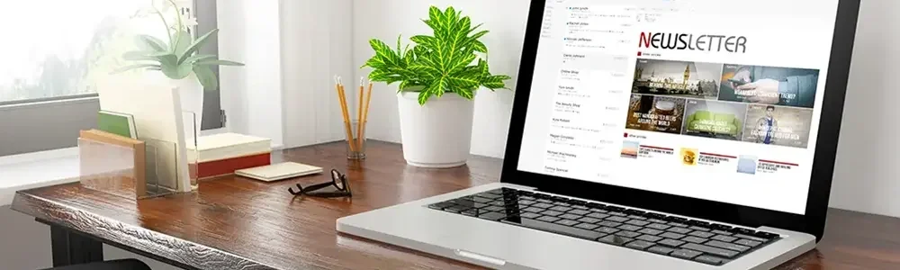 laptop on  a desk with newsletter on the screen