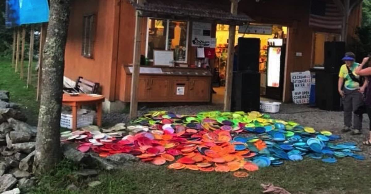 A pile of discs in front of a wooden building