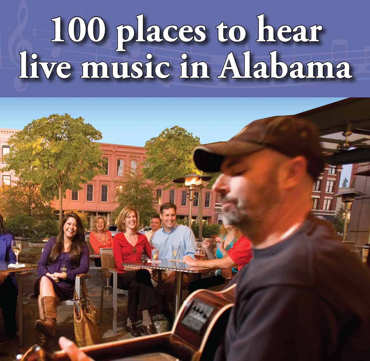 Group of people watching a man play guitar live music in Alabama