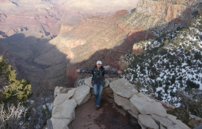 Jin Han, Embryologist at PFC standing on a cliff near the Grand Canyon