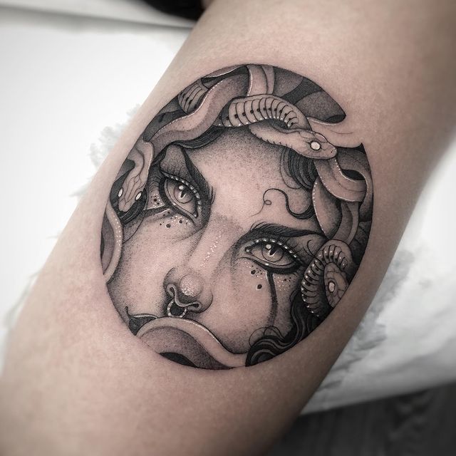 dotwork tattoo of medusa eyes in the arm realistic