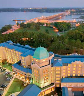 Arial view of a building with a bridge in the background