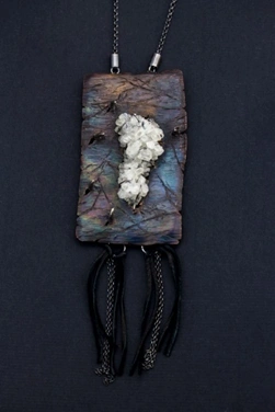 Raw crystal  pendant set with prongs into distressed copper with leather tassels