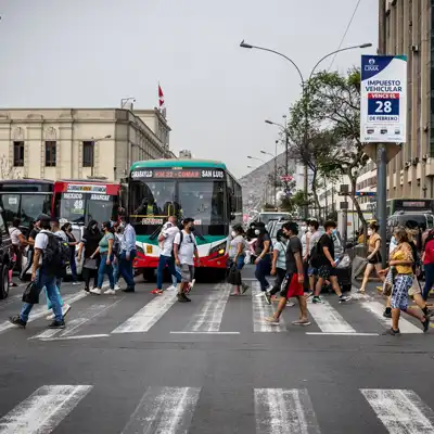 Crowded crosswalk with city buses