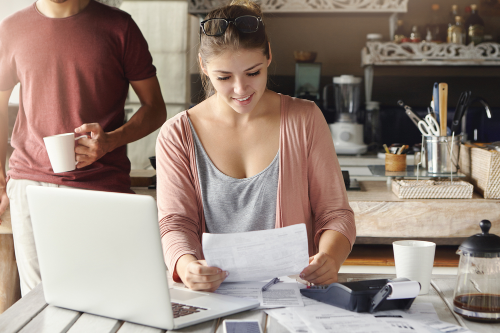 Couple looking at documents in their kitchen
