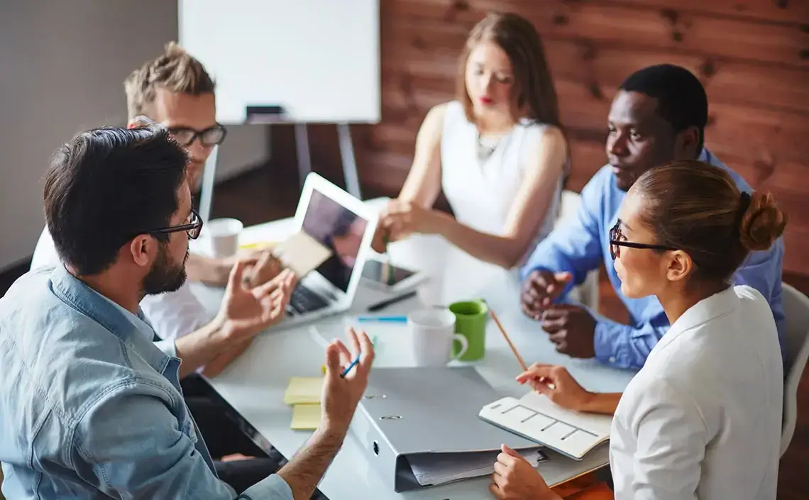 Five individuals having a work meeting.