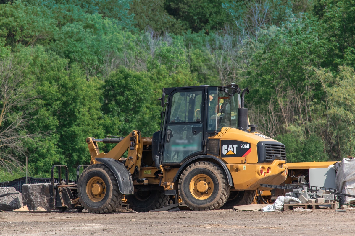 Caterpillar wheel loader with a fork attachment moving materials