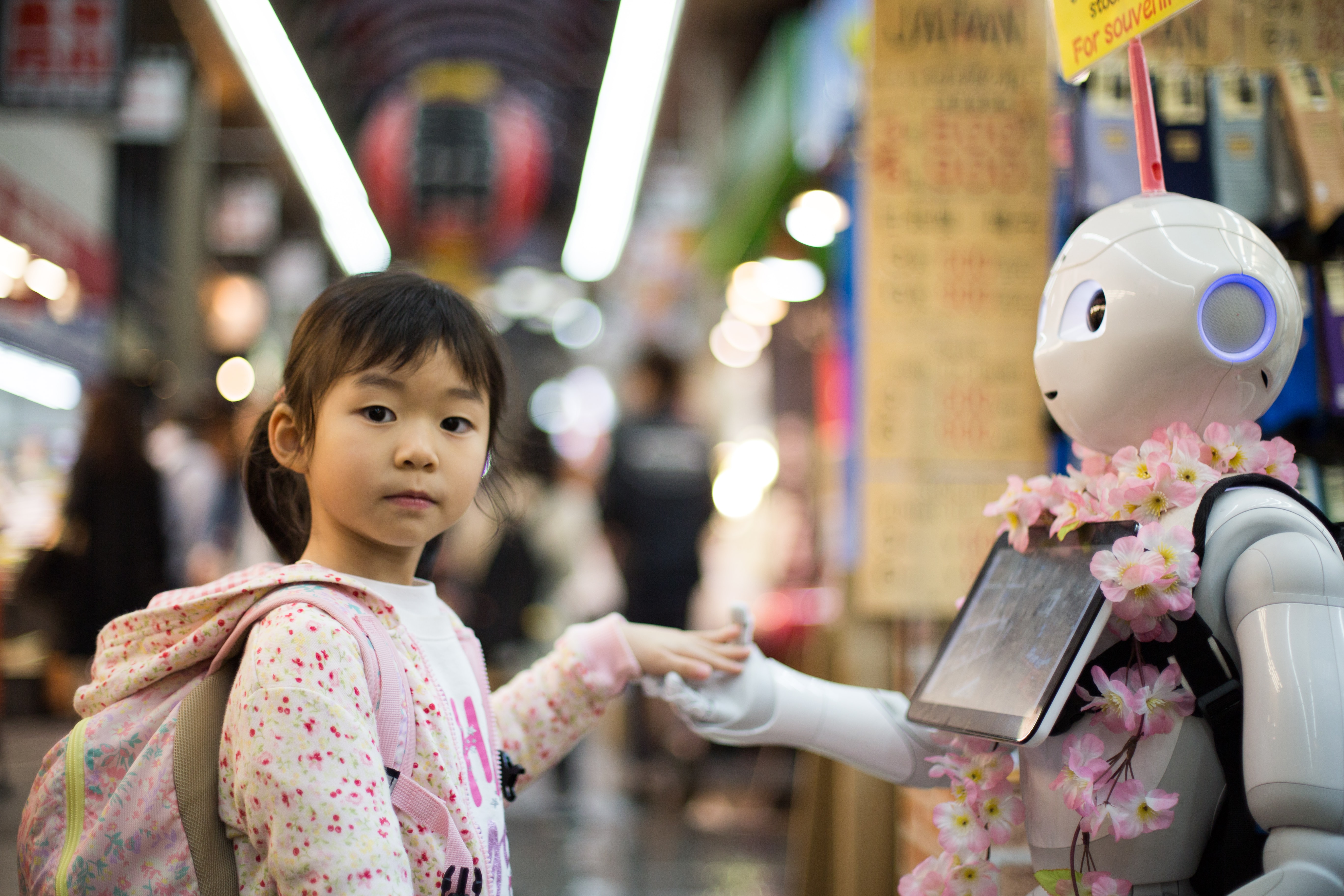 Little girl playing with robot in Japan