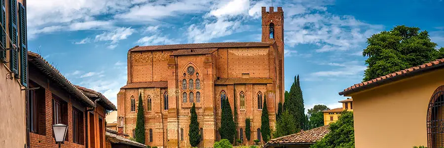 Brown church stands atop a hillside village.