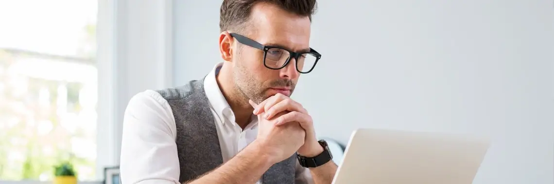 Man staring at computer screen.