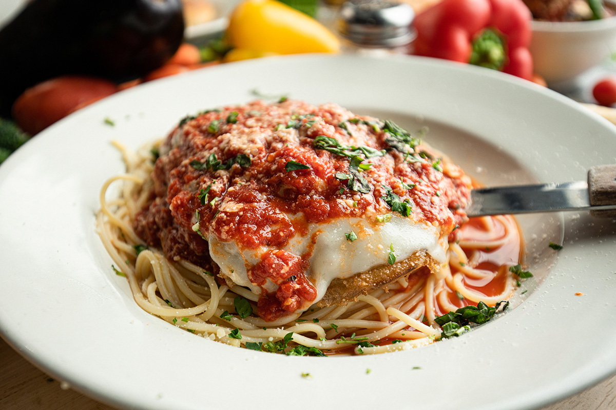 chicken parmesan with spaghetti sauce and cheese on a plate