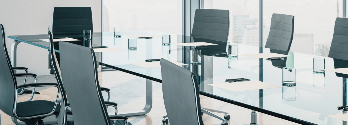 glass table top surrounded by chairs in office