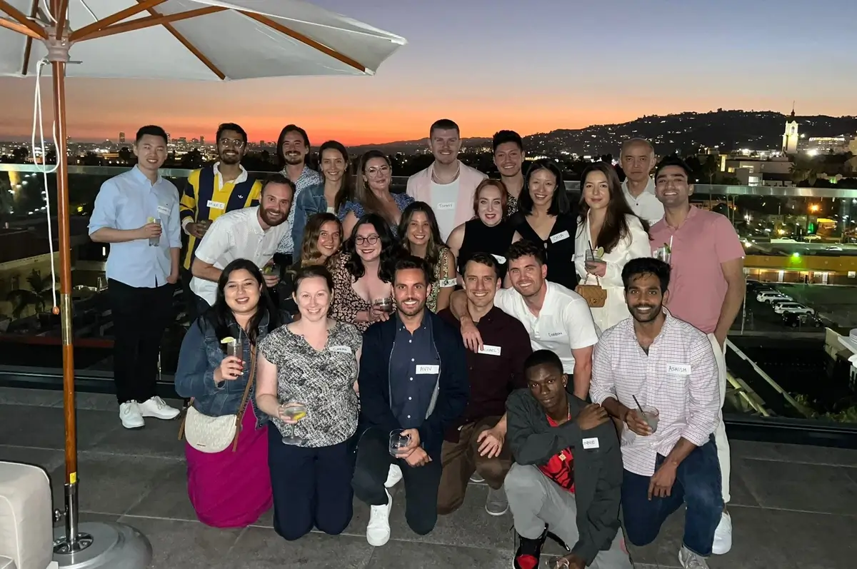 Skylight team photo on rooftop with sunset in the background