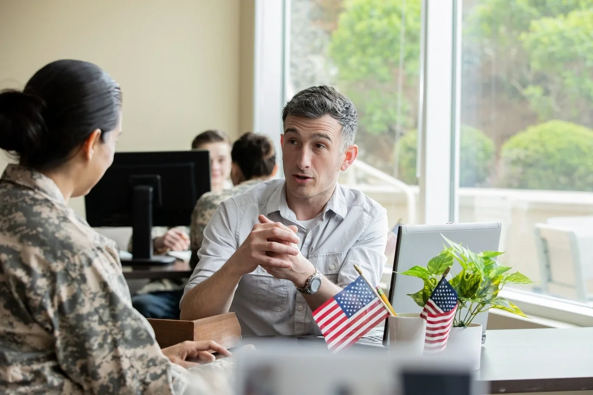 an image of a man talking to a woman in uniform