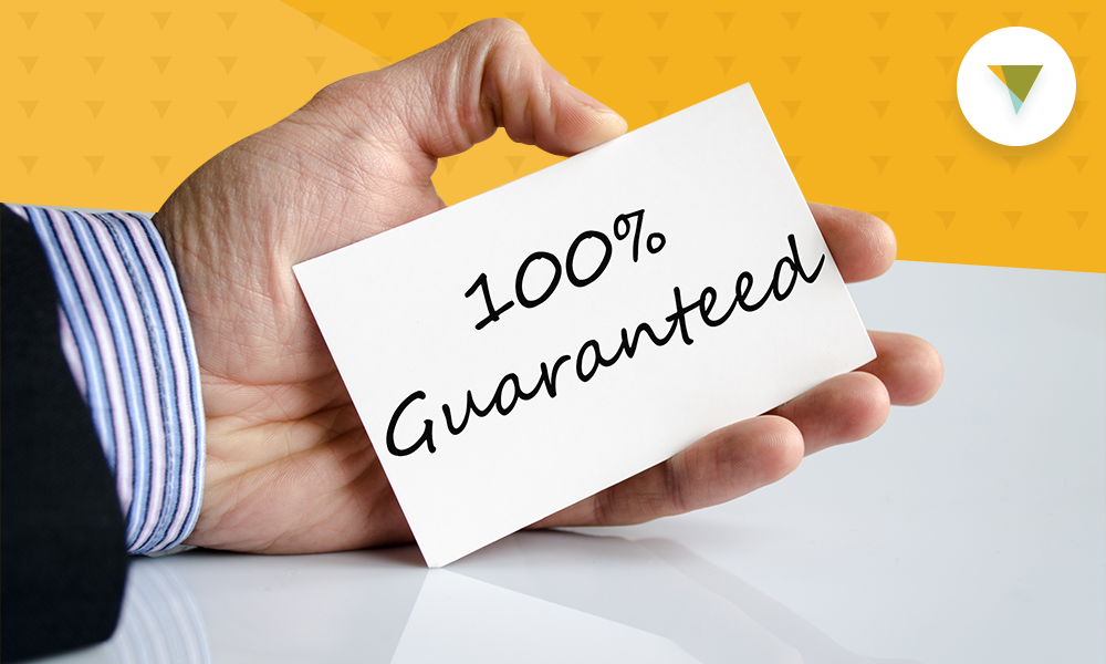 Man holding card that says "100% guaranteed."