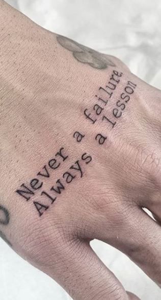 quote tattoo on man's hand