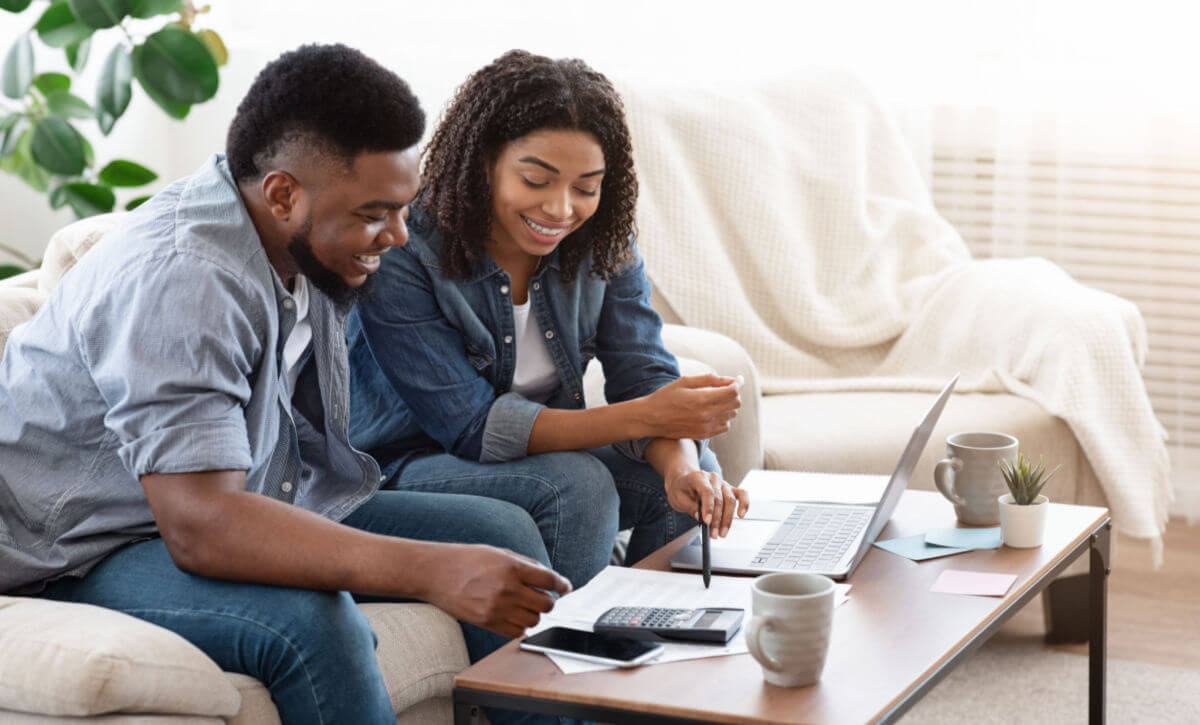 a black couple practices good spending habits by budgeting