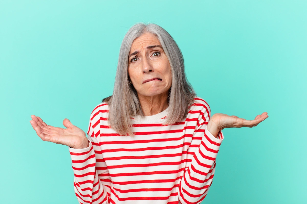 Medicare beneficiary holding up hands wondering if she should by a medicare supplement plan