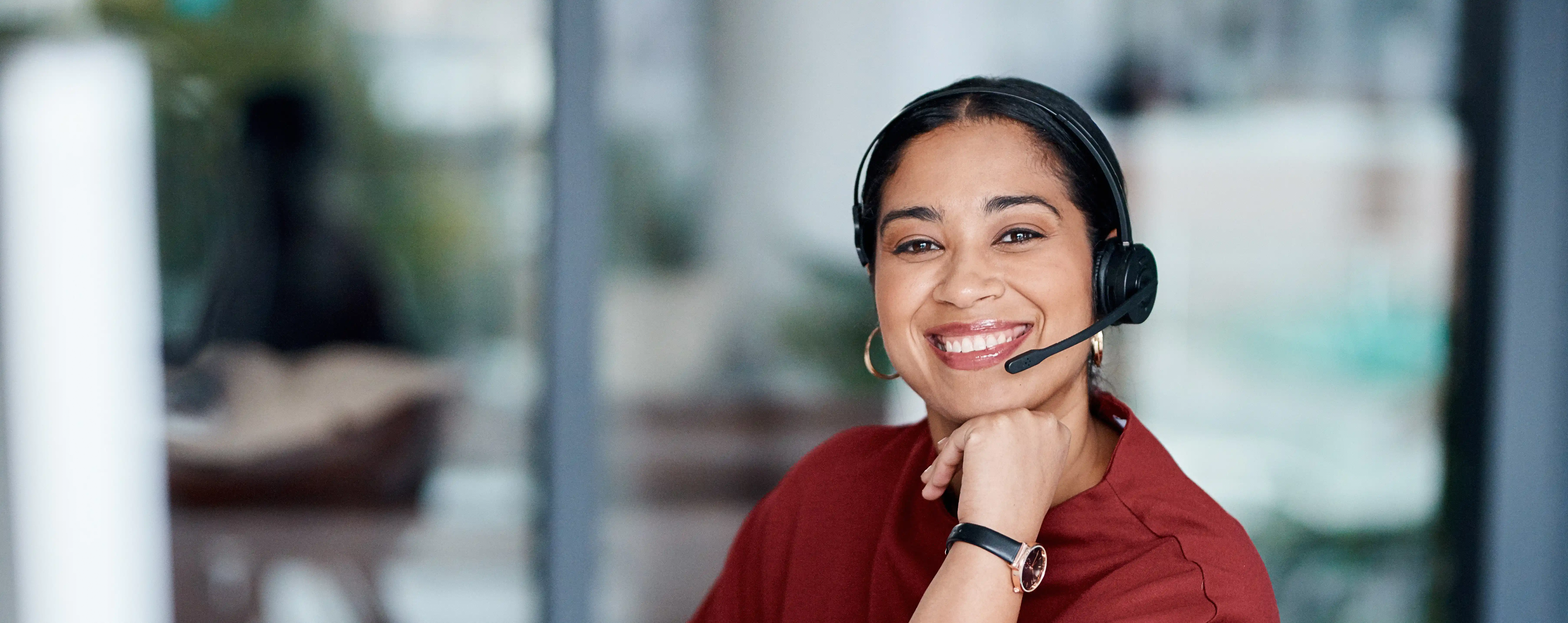 Smiling businesswoman with headset representing ethical customer support in B Corp managed teams