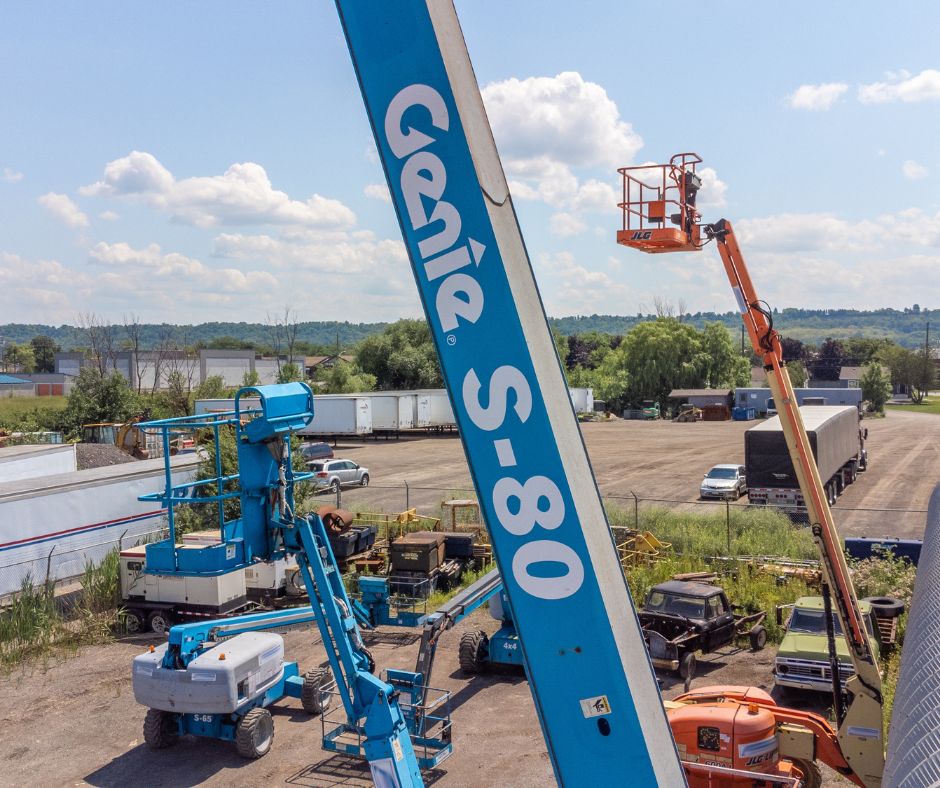Genie S-80 boom on a rental yard with other boom lifts
