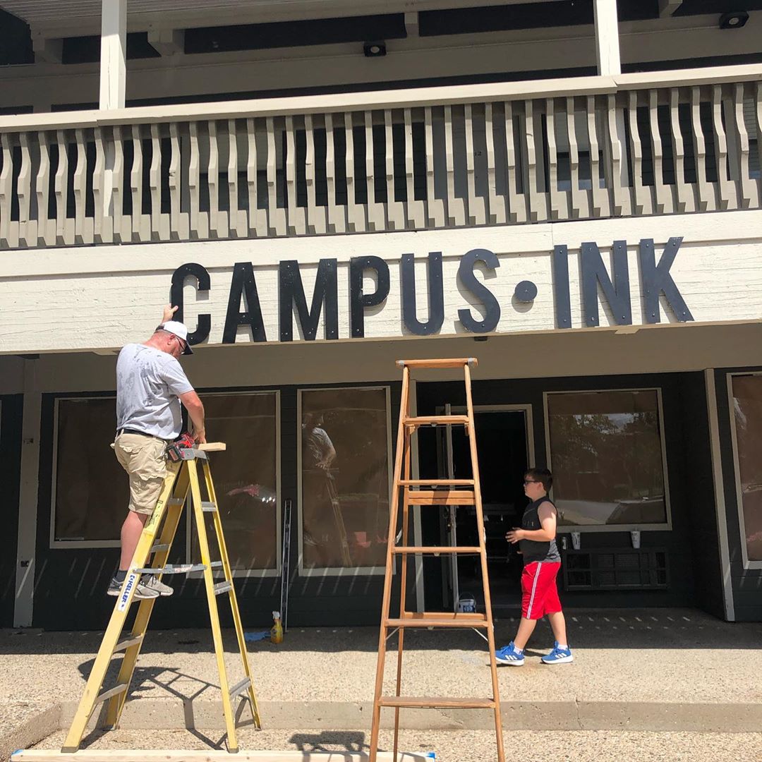 Jedd works on the Campus Ink sign.