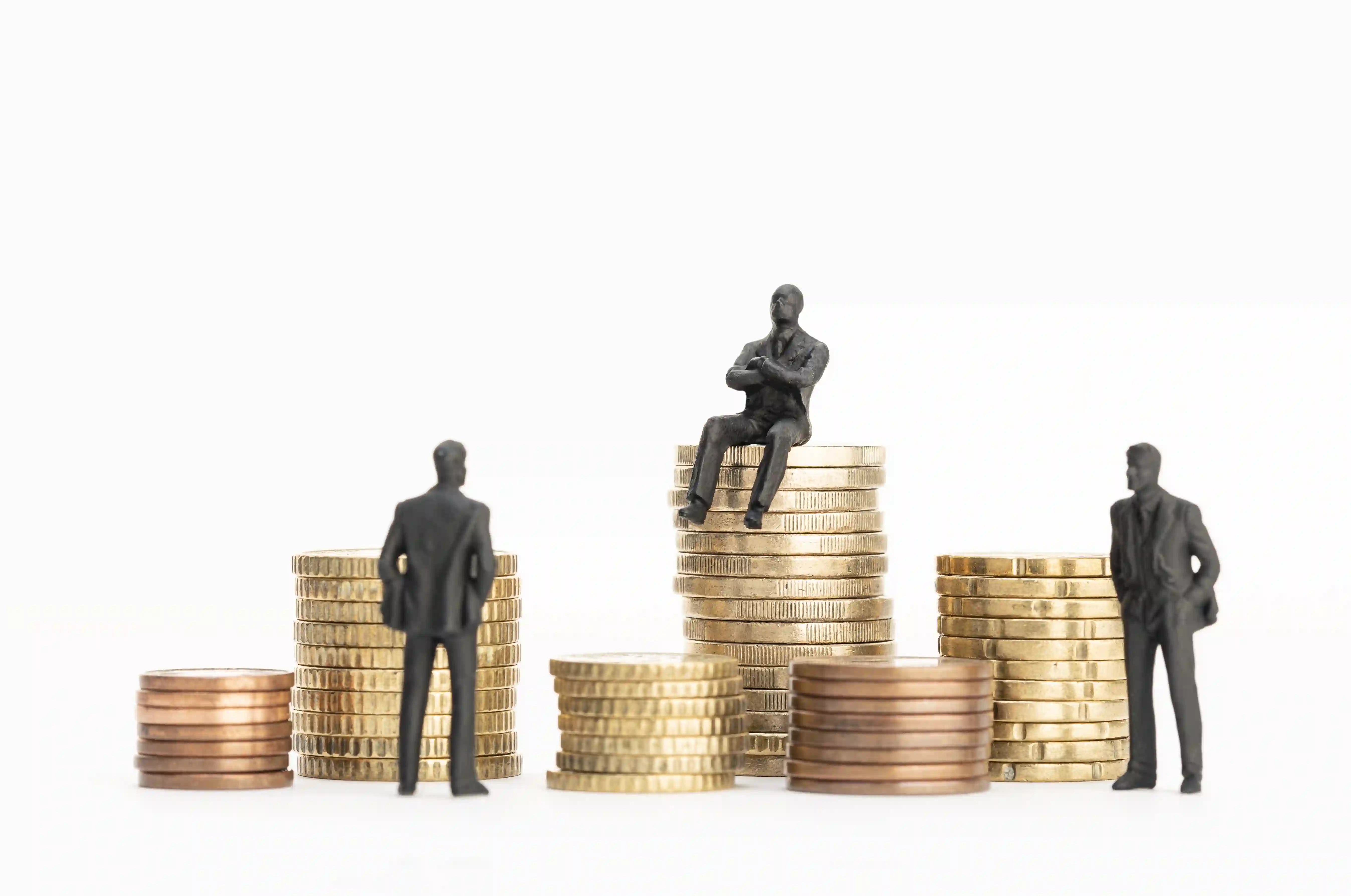 Business figures on stacked coins representing ROI and financial growth through efficiency