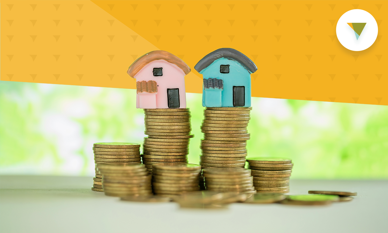 Small clay models of houses sitting atop stacks of coins.