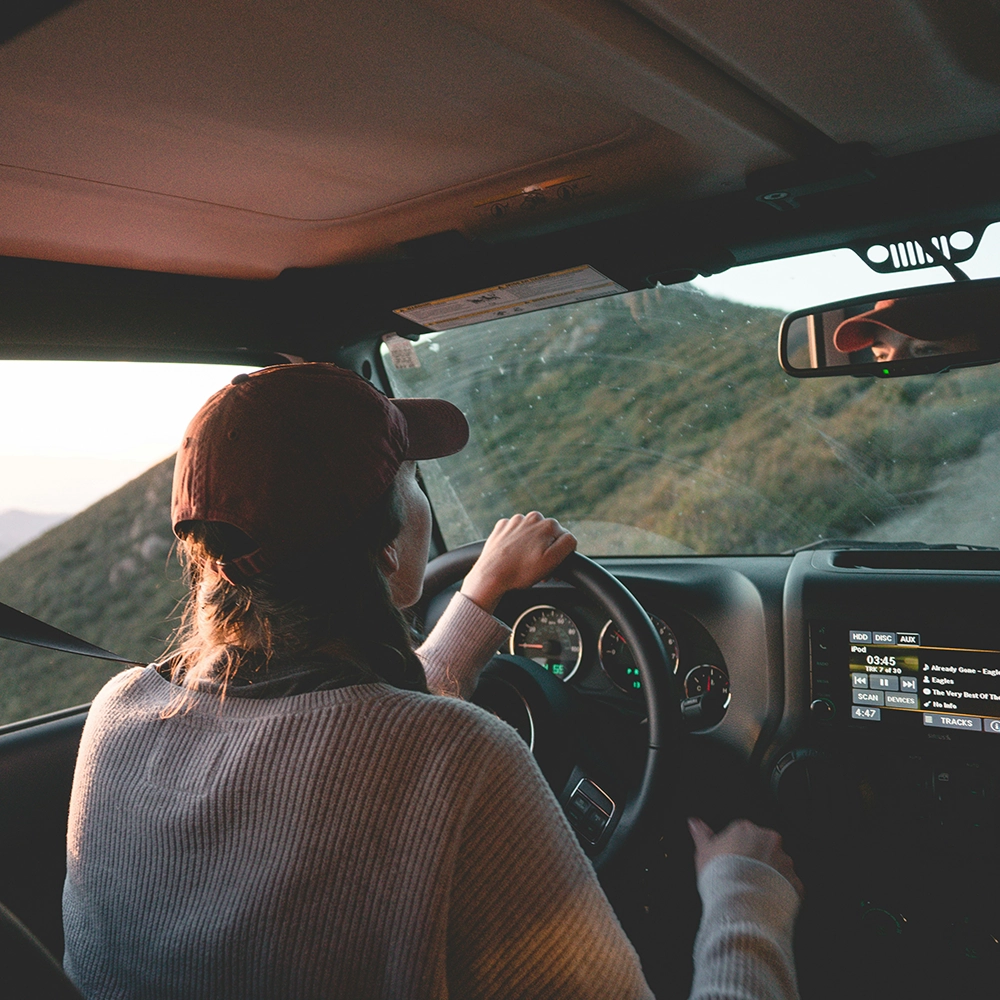 Girl driving through the mountains