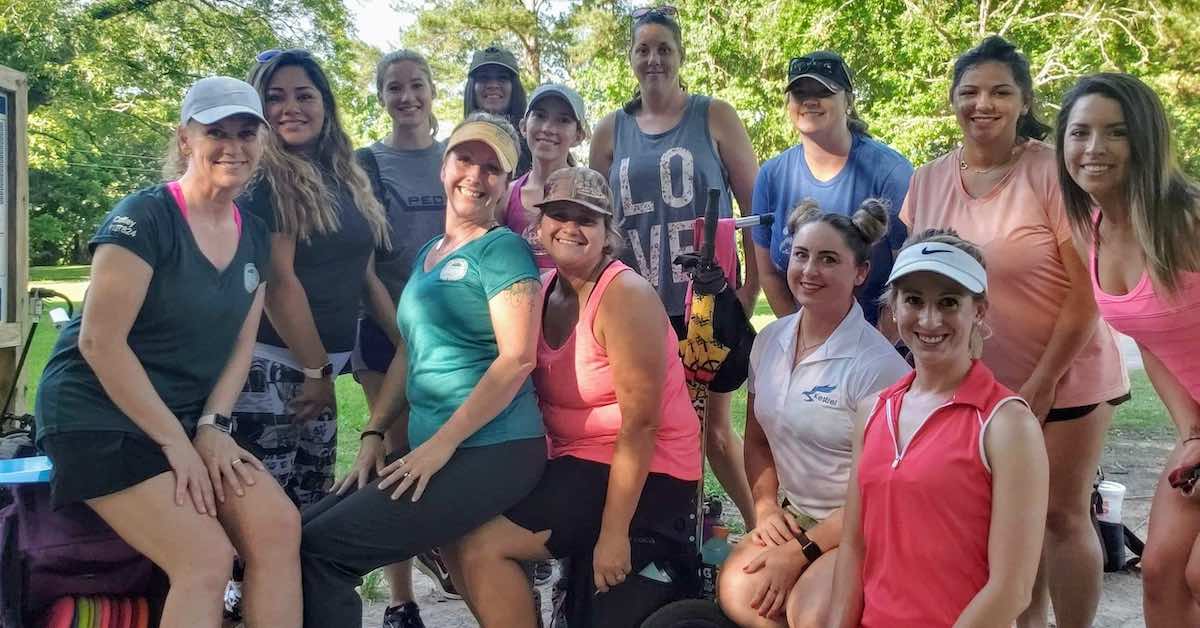 A group of women disc golfers smiling for the camera