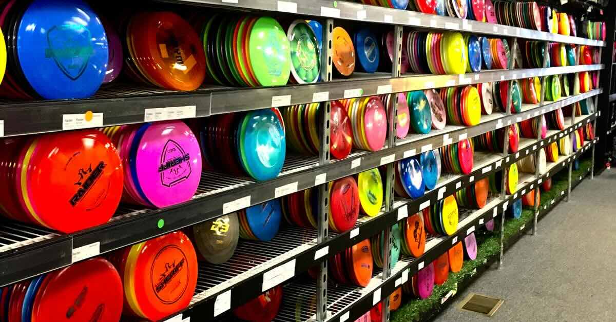 View of a large disc golf disc selection on racks