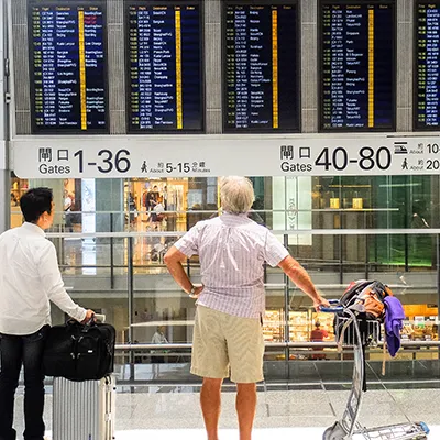 People looking at flight schedule.