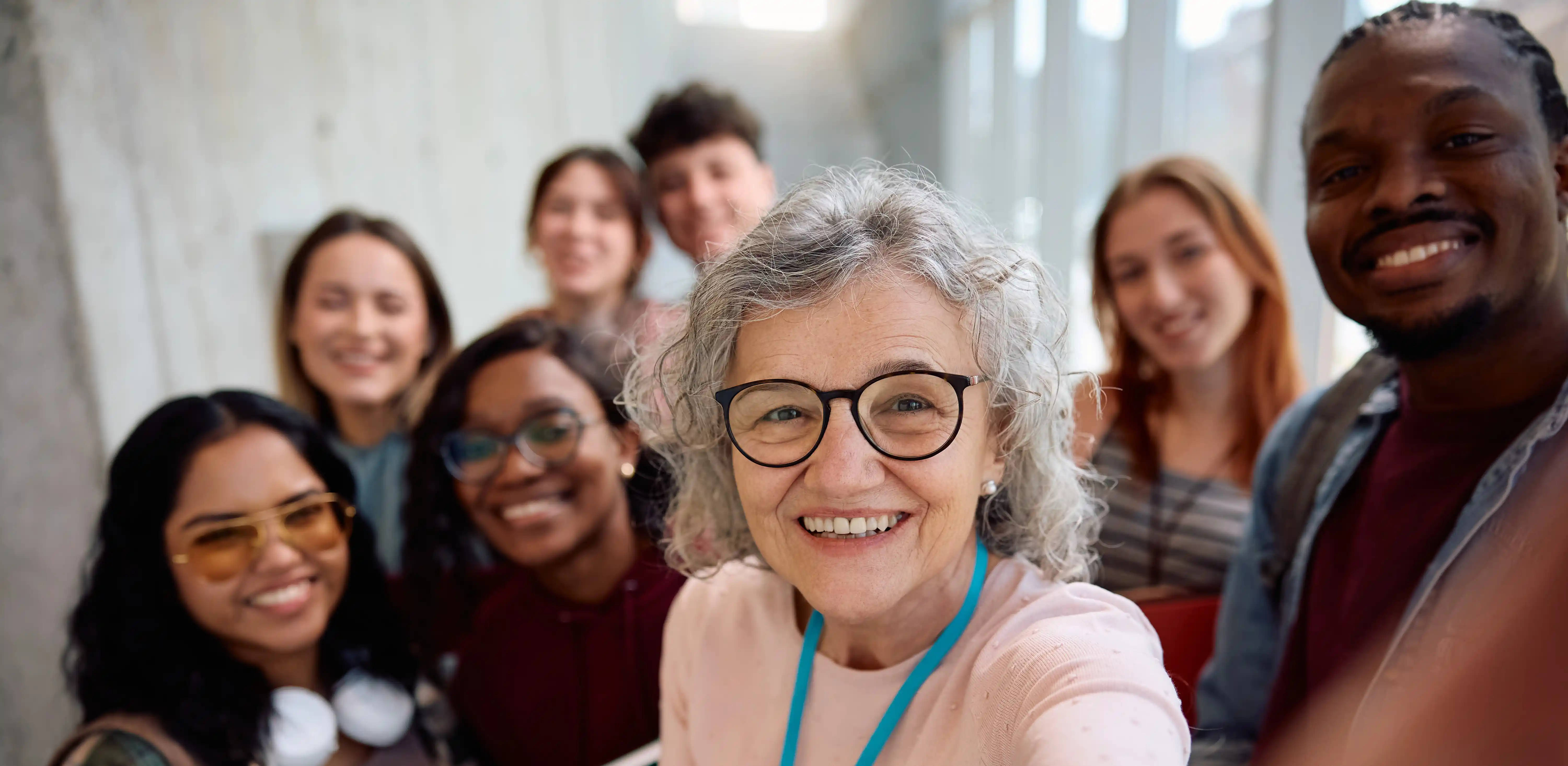 Smiling professor with diverse students representing B Corp social impact and talent development