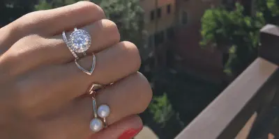 3 carat diamond in halo setting on hand