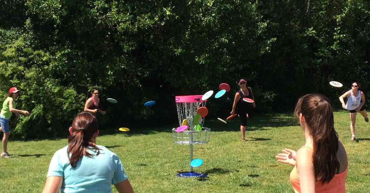 Women disc golfers doing ring of fire