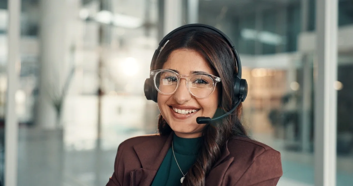 Customer service representative smiling at desk