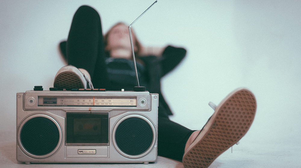 Woman lying down listening to boombox