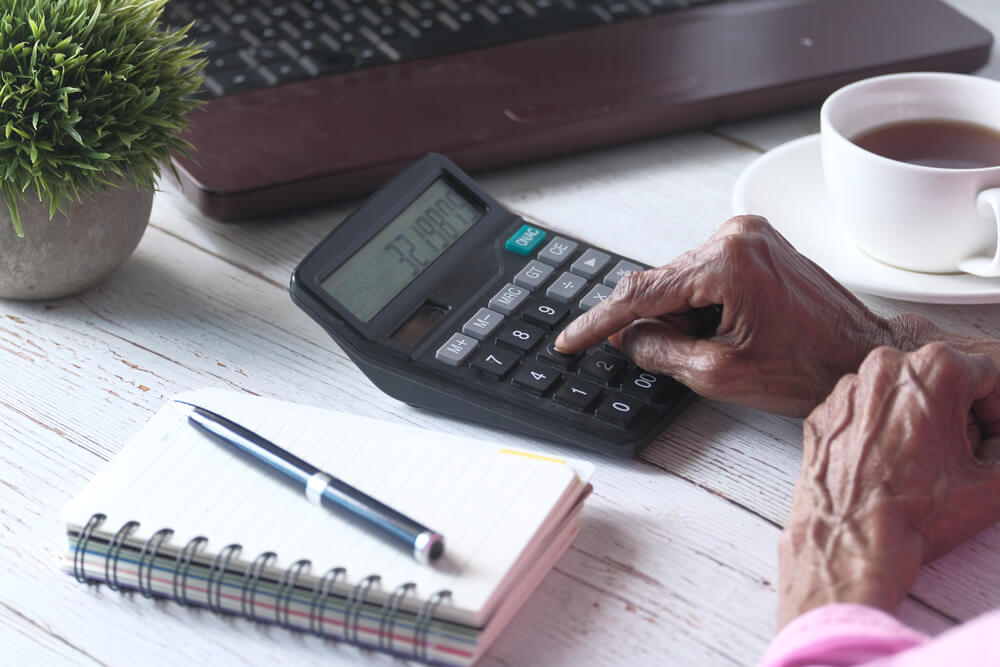 Elderly woman working on personal finances