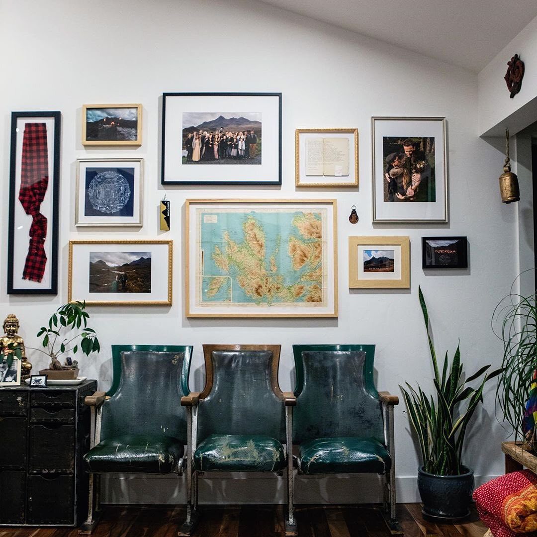 custom gallery wall over green chairs