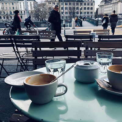 Having coffee at a cafe.