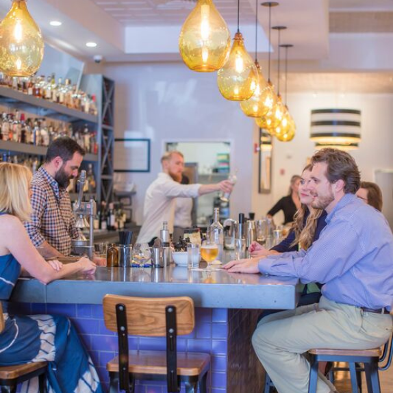 People enjoying meal inside restaurant.