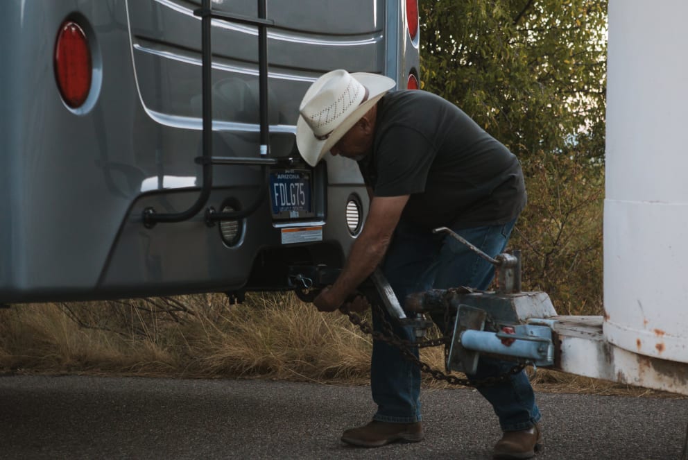 man attaching horse trailer to entegra accolade