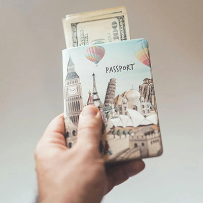 Man holding a passport with money.