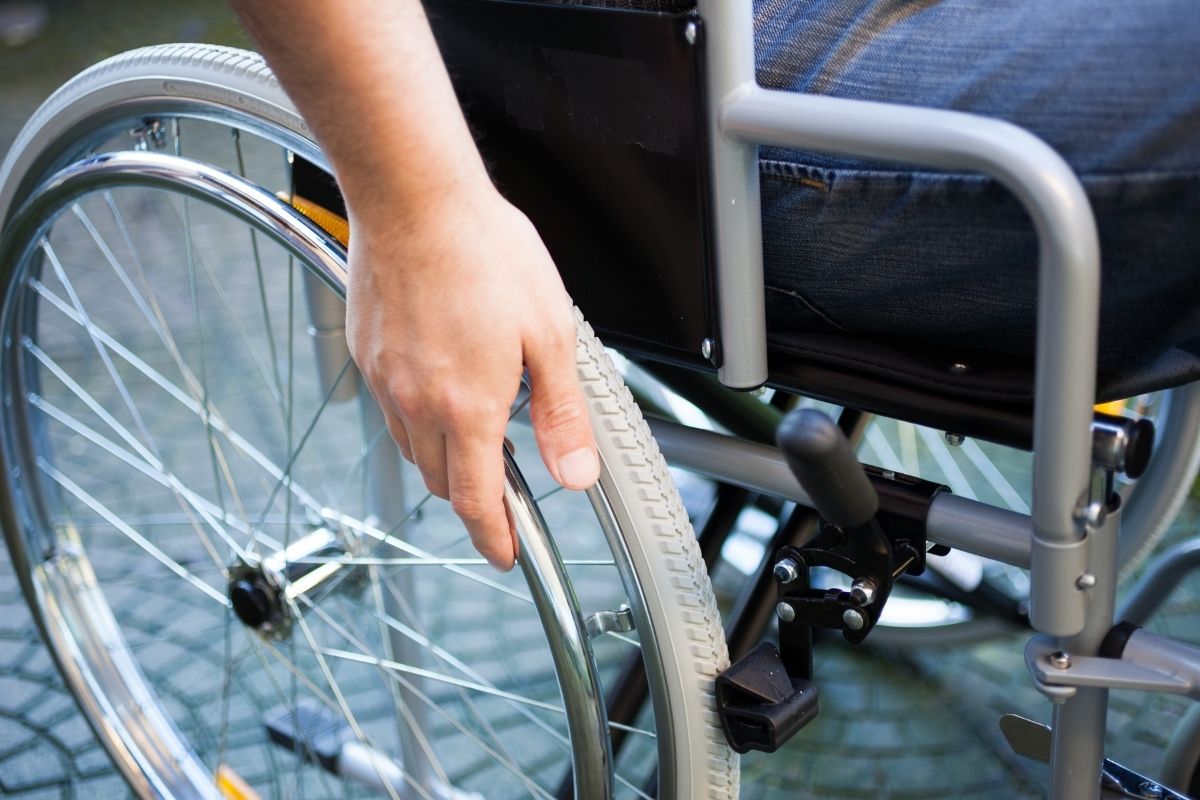 person using a wheelchair, an example of durable medical equipment