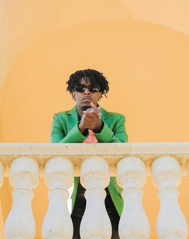 man in colorful suit on railing