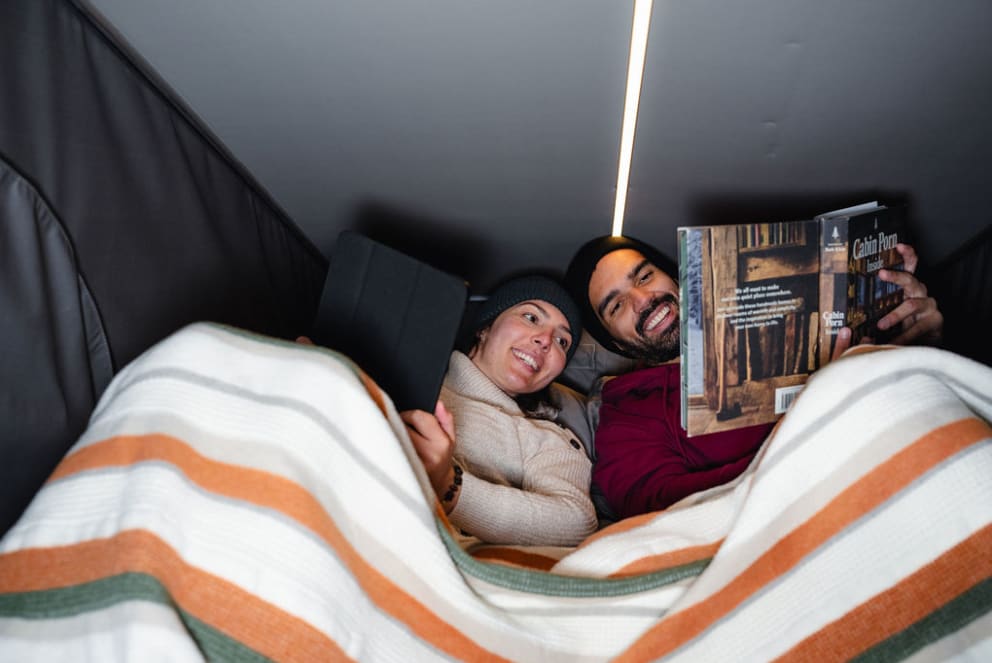 couple sleeping inside westfalia rv