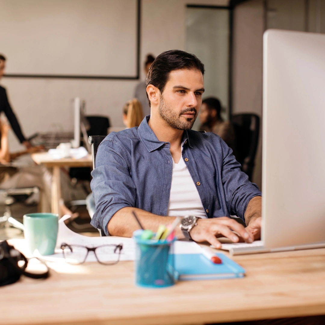 An employee using his Zoho account on the computer.