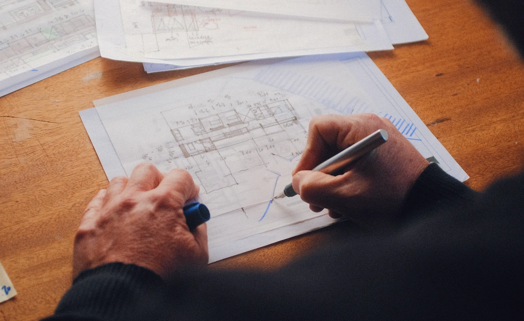 architect drawing a house plan